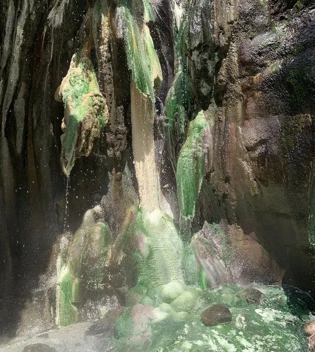 jade colored rocks with water dripping down